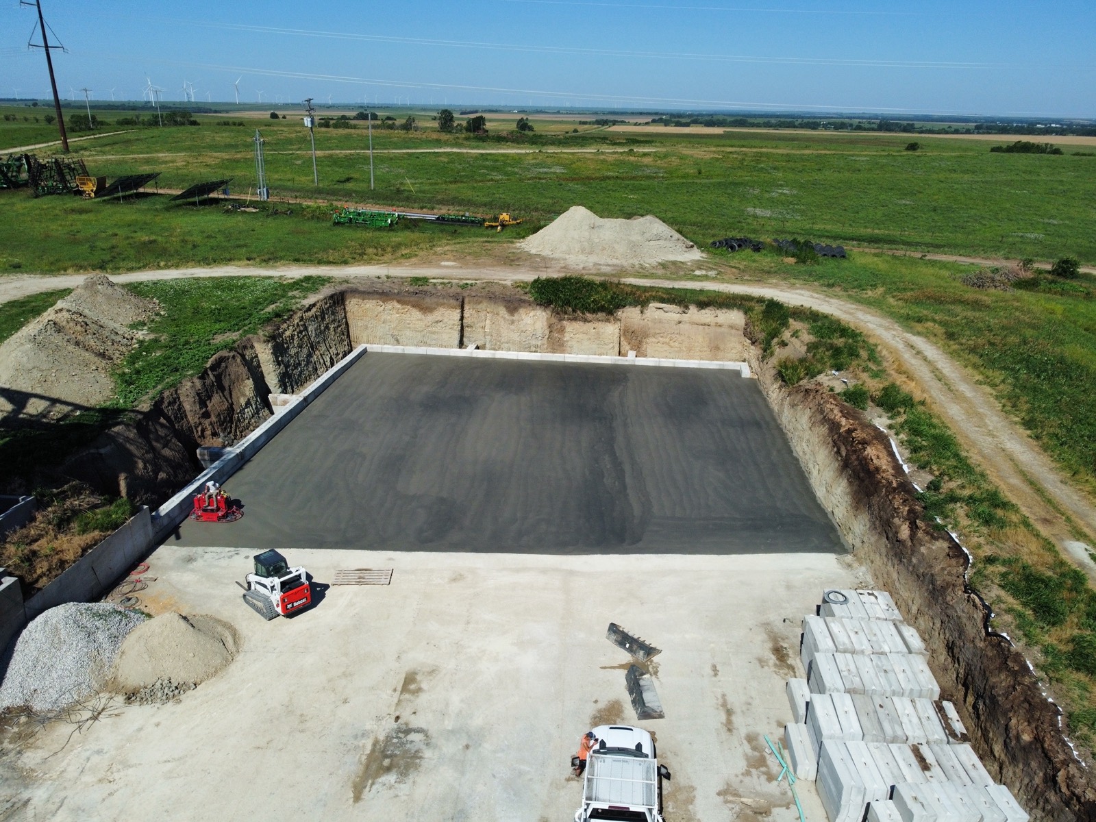 Finished concrete slab poured in the excavated pit