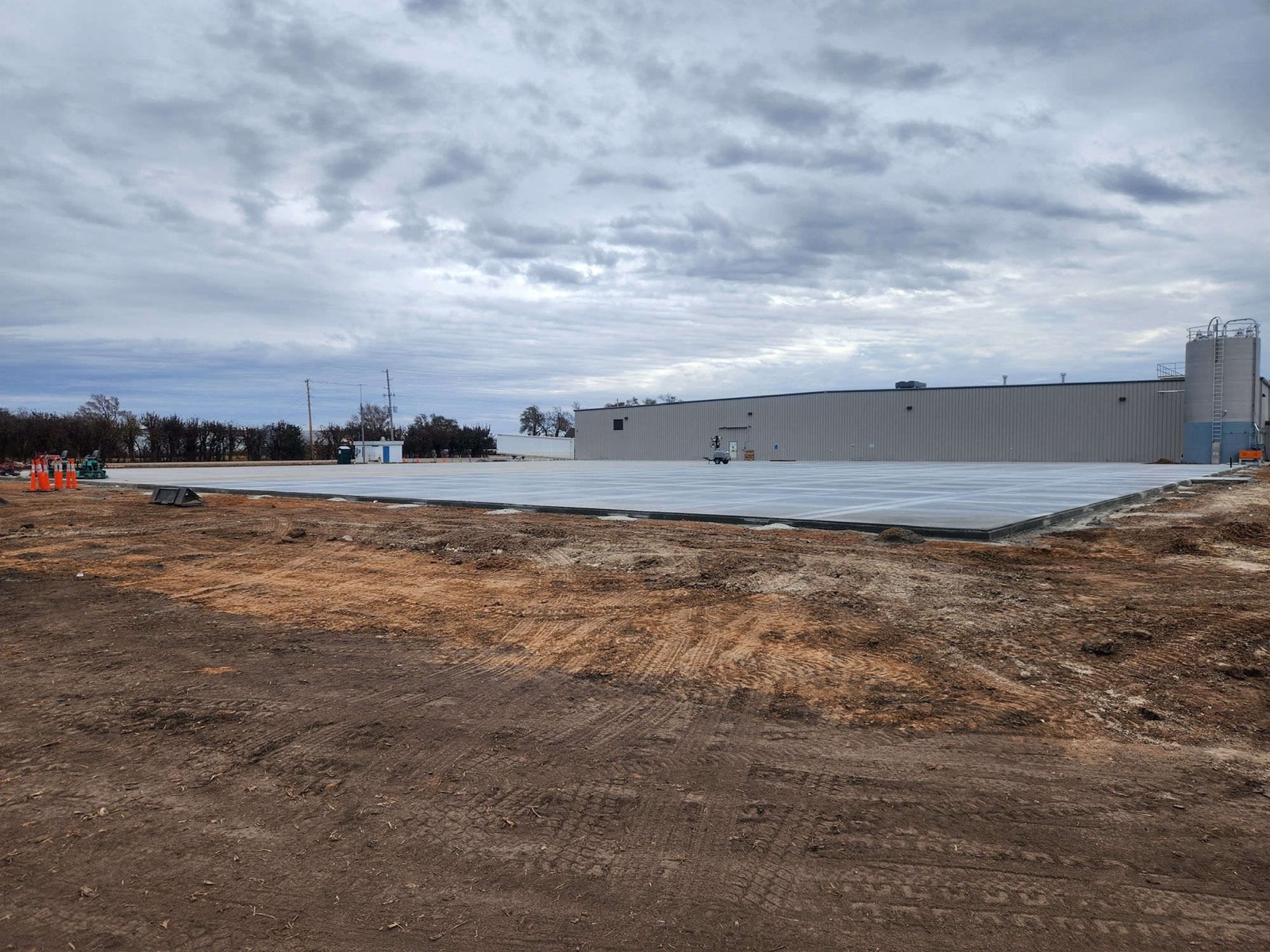 Large commercial concrete slab beside a warehouse